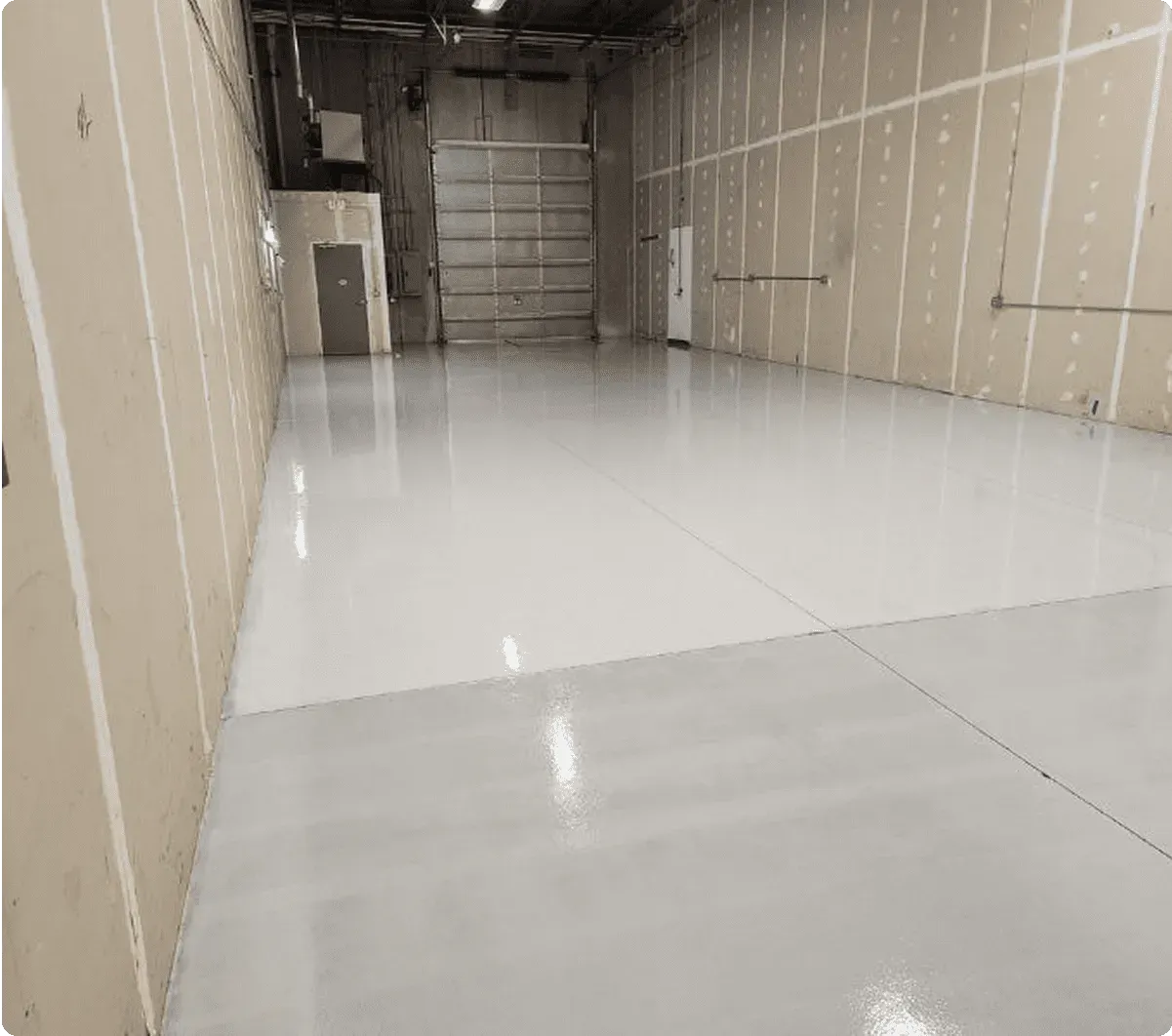 A commercial warehouse space with light-colored polished concrete coated flooring.