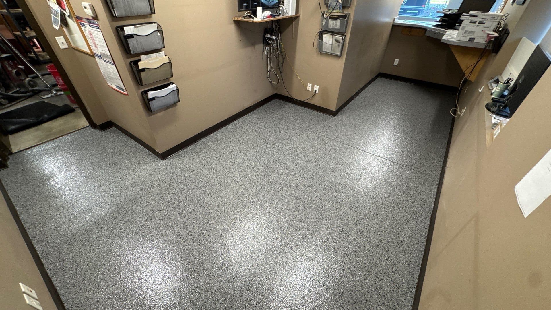 An office space with newly-coated Polyurea flake flooring.