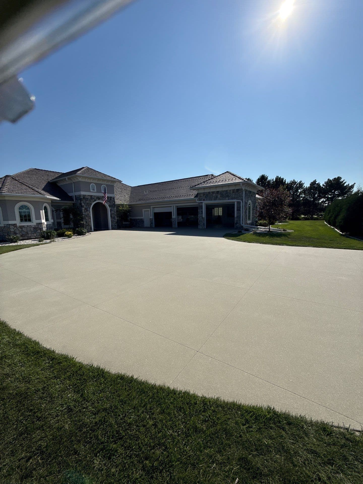 A light, solid-colored concrete coated Resist driveway.