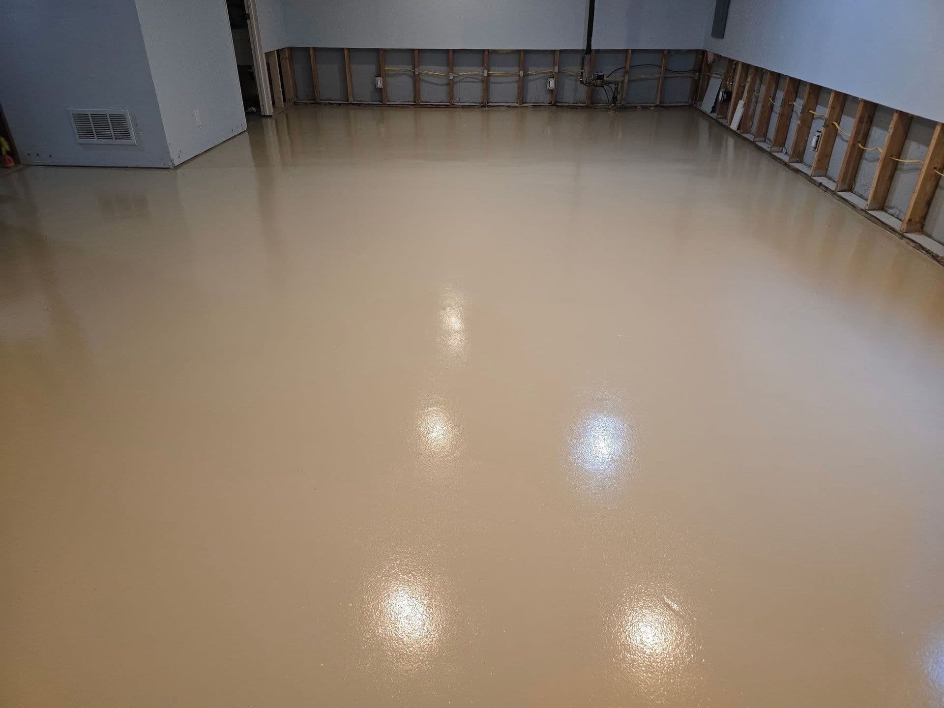 Newly-coated solid color concrete flooring.